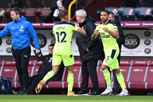 Dwight Gayle of Newcastle United is replaced by Callum Wilson of Newcastle United during the Premier League match between Burnley and Newcastle United at Turf Moor on April 11, 2021 in Burnley, England.