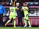 Dwight Gayle of Newcastle United is replaced by Callum Wilson of Newcastle United during the Premier League match between Burnley and Newcastle United at Turf Moor on April 11, 2021 in Burnley, England.
