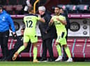 Dwight Gayle of Newcastle United is replaced by Callum Wilson of Newcastle United during the Premier League match between Burnley and Newcastle United at Turf Moor on April 11, 2021 in Burnley, England.