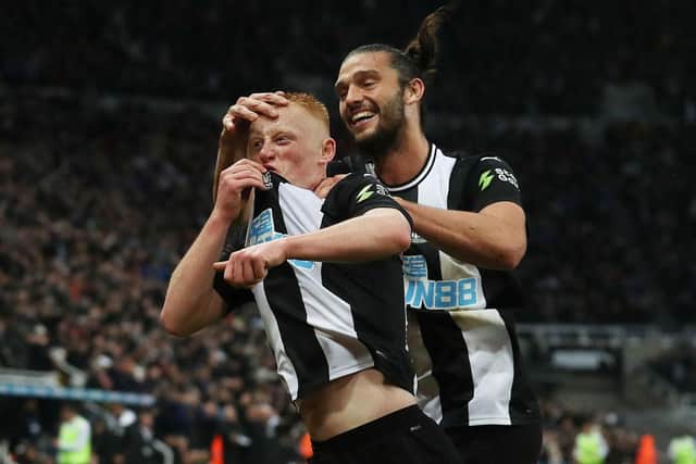 Matty Longstaff of Newcastle United celebrates with team mate Andy Carroll after he scores the only goal of the game during the Premier League match between Newcastle United and Manchester United at St. James Park on October 06, 2019 in Newcastle upon Tyne.