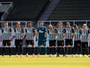 Players of Newcastle United observe two minutes of silence prior to kick off in memory of Prince Philip, Duke of Edinburgh during the Premier League match between Newcastle United and West Ham United at St. James Park on April 17, 2021 in Newcastle upon Tyne, England.