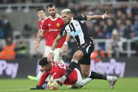 Joelinton of Newcastle United runs with the ball past Jadon Sancho of Manchester United during the Premier League match between Newcastle United and Manchester United at St James' Park on December 27, 2021 in Newcastle upon Tyne, England. (Photo by Ian MacNicol/Getty Images)