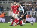 Joelinton of Newcastle United runs with the ball past Jadon Sancho of Manchester United during the Premier League match between Newcastle United and Manchester United at St James' Park on December 27, 2021 in Newcastle upon Tyne, England. (Photo by Ian MacNicol/Getty Images)
