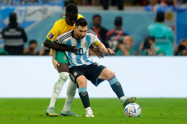 Argentina's forward #10 Lionel Messi and Australia's forward #21 Garang Kuol fight for the ball during the Qatar 2022 World Cup round of 16 football match between Argentina and Australia at the Ahmad Bin Ali Stadium in Al-Rayyan, west of Doha on December 3, 2022. (Photo by Odd ANDERSEN / AFP) (Photo by ODD ANDERSEN/AFP via Getty Images)