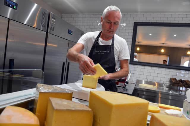 Blacks Corner Deli and Bakehouse deli manager John Craig prepares cheese on the open counter