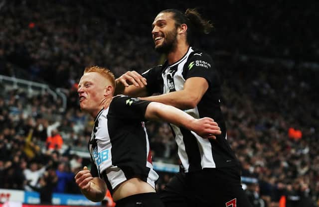 Matty Longstaff of Newcastle United celebrates with team mate Andy Carroll after he scores the only goal of the game during the Premier League match between Newcastle United and Manchester United at St. James Park on October 06, 2019 in Newcastle upon Tyne, United Kingdom.