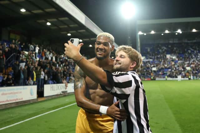 Joelinton of Newcastle United poses for a photo with a fan after the Carabao Cup Second Round match between Tranmere Rovers and Newcastle United at Prenton Park. (Photo by Lewis Storey/Getty Images)