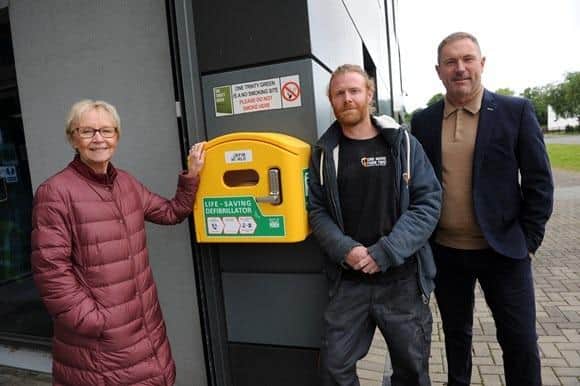 Cllr Anne Hetherington with One More Than Brewery's Christopher Donovan and Shark Digital Display's Ian Trotter with the newly installed defibrillator at One Trinity Green, South Shields.