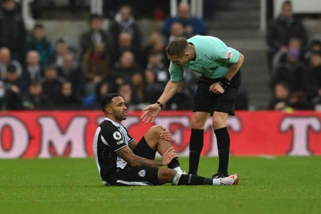Callum Wilson of Newcastle United reacts with an injury during the Premier League match between Newcastle United  and  Manchester United at St James' Park  (Photo by Stu Forster/Getty Images)