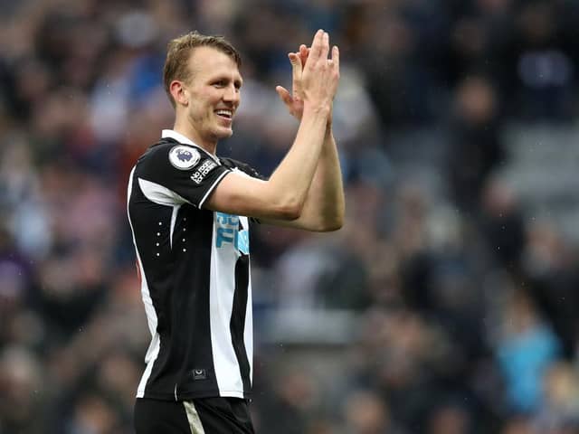 Dan Burn applauds fans after his debut.