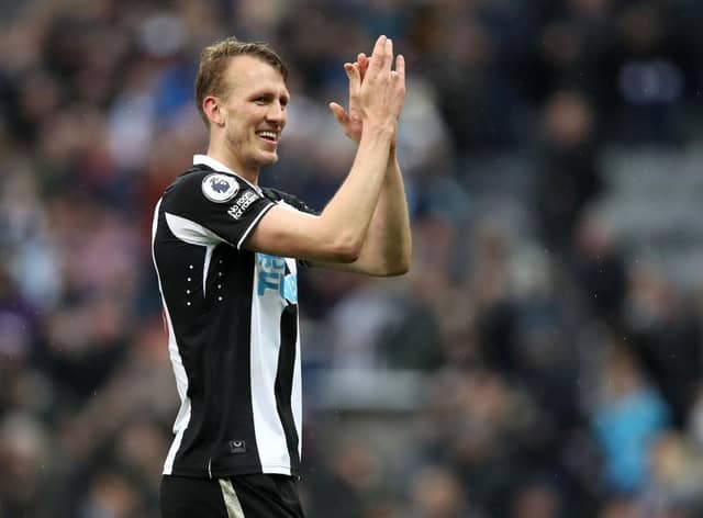 Dan Burn applauds fans after his debut.