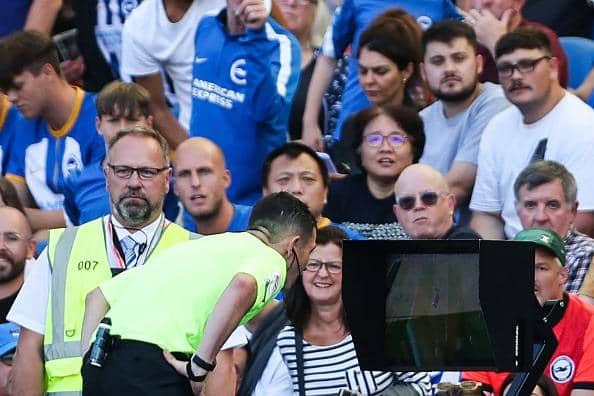 Tony Harrington checks the VAR screen during a Premier League match at Brighton.  