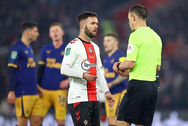 Adam Armstrong of Southampton speaks to Referee Stuart Attwell, after scoring a goal which was dissallowed following a handball decision via a VAR review, during the Carabao Cup Semi Final 1st Leg match between Southampton and Newcastle United at St Mary's Stadium on January 24, 2023 in Southampton, England. (Photo by Michael Steele/Getty Images)