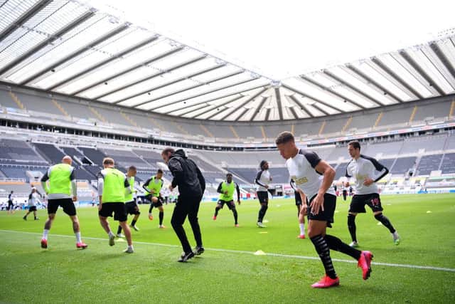 NEWCASTLE UPON TYNE, ENGLAND - JULY 26: Dwight Gayle of Newcastle United and teammates warm up prior to the Premier League match between Newcastle United and Liverpool FC at St. James Park on July 26, 2020 in Newcastle upon Tyne, England. Football Stadiums around Europe remain empty due to the Coronavirus Pandemic as Government social distancing laws prohibit fans inside venues resulting in all fixtures being played behind closed doors. (Photo by Laurence Griffiths/Getty Images)