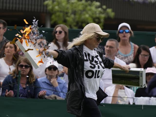 A Just Stop Oil protester runs onto Court 18 and releases confetti