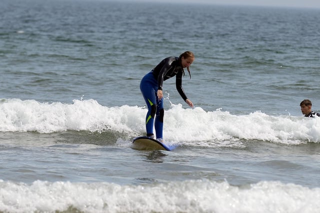 Surfer rides the waves at Sandhaven beach