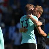 Brighton's English manager Graham Potter (R) and Brighton's English defender Dan Burn (L) embrace on the pitch after the English Premier League football match between Brighton and Hove Albion and Newcastle United at the American Express Community Stadium in Brighton, southern England on August 13, 2022. (Photo by GLYN KIRK/AFP via Getty Images)