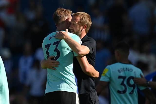 Brighton's English manager Graham Potter (R) and Brighton's English defender Dan Burn (L) embrace on the pitch after the English Premier League football match between Brighton and Hove Albion and Newcastle United at the American Express Community Stadium in Brighton, southern England on August 13, 2022. (Photo by GLYN KIRK/AFP via Getty Images)