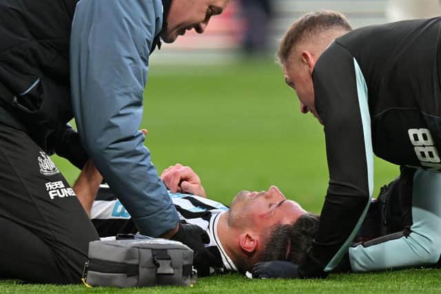 Newcastle United defender Fabian Schar receives medical treatment after clashing heads with Manchester United defender Lisandro Martinez at Wembley.