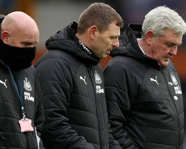 Newcastle United head coach Steve Bruce pictured alongside assistant coaches Graeme Jones and Steve Agnew. (Photo by CLIVE BRUNSKILL/POOL/AFP via Getty Images)