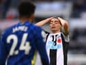 Miguel Almiron reacts dejectedly as Reece James of Chelsea looks on.