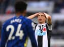 Miguel Almiron reacts dejectedly as Reece James of Chelsea looks on.