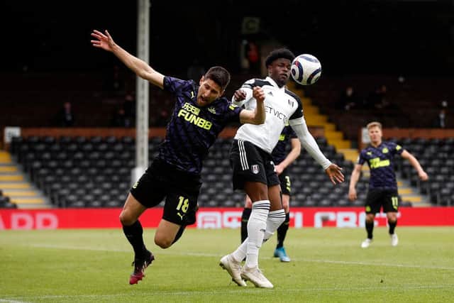 Federico Fernandez of Newcastle United clashes with Josh Maja of Fulham during the Premier League match between Fulham and Newcastle United at Craven Cottage on May 23, 2021 in London, England.A limited number of fans will be allowed into Premier League stadiums as Coronavirus restrictions begin to ease in the UK. (Photo by Matthew Childs - Pool/Getty Images)