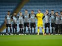 MANCHESTER, ENGLAND - DECEMBER 26: Newcastle United players stand for a minutes silence to remember the lives lost this year associated with football prior to the Premier League match between Manchester City and Newcastle United at Etihad Stadium on December 26, 2020 in Manchester, England. The match will be played without fans, behind closed doors as a Covid-19 precaution. (Photo by Clive Brunskill/Getty Images)