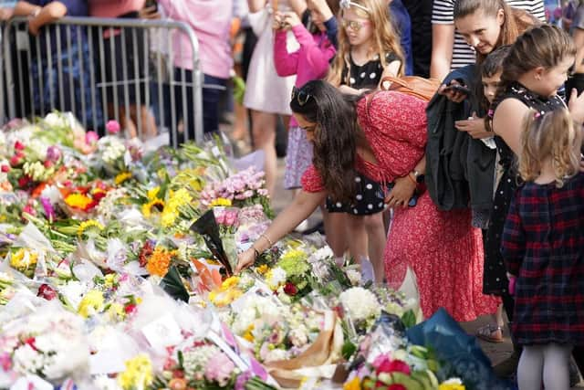 Floral tributes laid at the gates of Windsor Castle in Berkshire, following the death of Queen Elizabeth II.