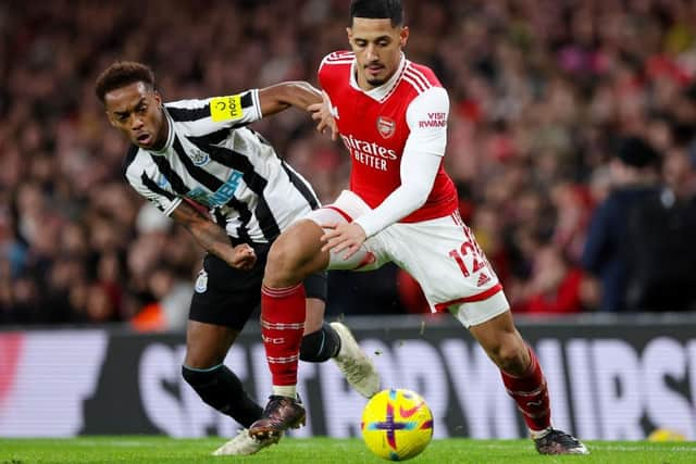 Newcastle United's Joe Willock challenges Arsenal's William Saliba.