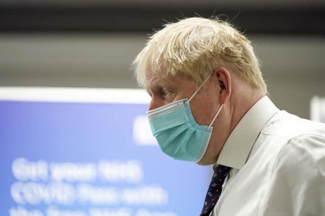 Prime Minister Boris Johnson during a visit to a vaccination hub in the Guttman Centre at Stoke Mandeville Stadium in Aylesbury, Buckinghamshire, as the booster vaccination programme continues. Picture date: Monday January 3, 2022.