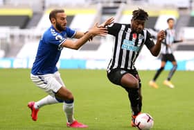 Everton's Cenk Tosun and Newcastle United's Allan Saint-Maximin battle for the ball.