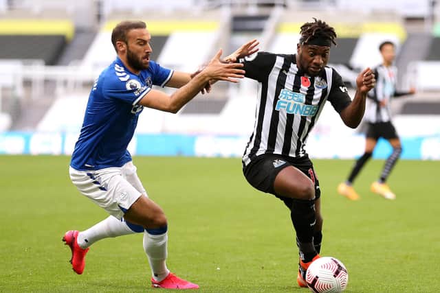 Everton's Cenk Tosun and Newcastle United's Allan Saint-Maximin battle for the ball.