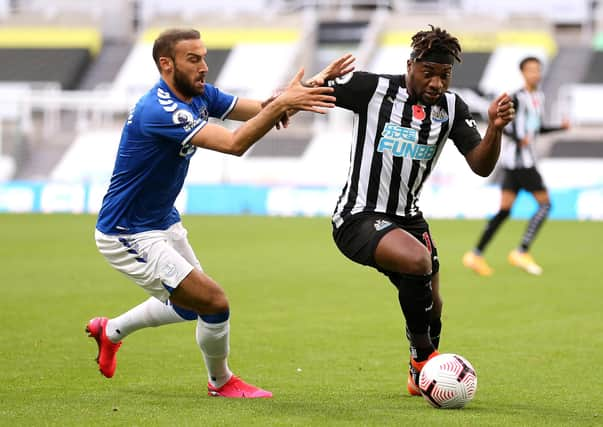 Everton's Cenk Tosun and Newcastle United's Allan Saint-Maximin battle for the ball.