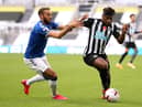 Everton's Cenk Tosun and Newcastle United's Allan Saint-Maximin battle for the ball.