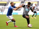 Everton's Cenk Tosun and Newcastle United's Allan Saint-Maximin battle for the ball.