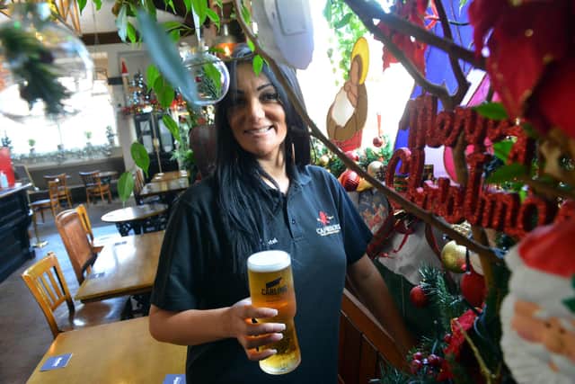 The New Cyprus Hotel owner Sinia Jazwi with the Christmas decorations inside the pub.