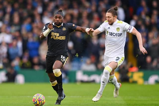 Allan Saint-Maximin of Newcastle United is challenged by Luke Ayling of Leeds United during the Premier League match between Leeds United and Newcastle United at Elland Road on January 22, 2022 in Leeds, England. (Photo by Stu Forster/Getty Images)