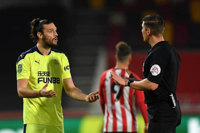 BRENTFORD, ENGLAND - DECEMBER 22: Andy Carroll of Newcastle United talks to Referee, Robert Jones during the Carabao Cup Quarter Final match between Brentford and Newcastle United at Brentford Community Stadium on December 22, 2020 in Brentford, England. The match will be played without fans, behind closed doors as a Covid-19 precaution. (Photo by Newcastle United/Newcastle United via Getty Images)