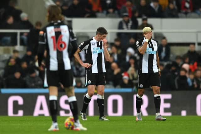 Ciaran Clark (c) and Joelinton of Newcastle react after the fourth City goal during the Premier League match between Newcastle United  and  Manchester City at St. James Park on December 19, 2021 in Newcastle upon Tyne, England. (Photo by Stu Forster/Getty Images)