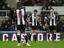 Ciaran Clark (c) and Joelinton of Newcastle react after the fourth City goal during the Premier League match between Newcastle United  and  Manchester City at St. James Park on December 19, 2021 in Newcastle upon Tyne, England. (Photo by Stu Forster/Getty Images)