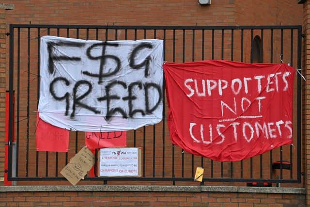 Banners critical of the European Super League project hang from the railings of Anfield.