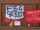 Banners critical of the European Super League project hang from the railings of Anfield.