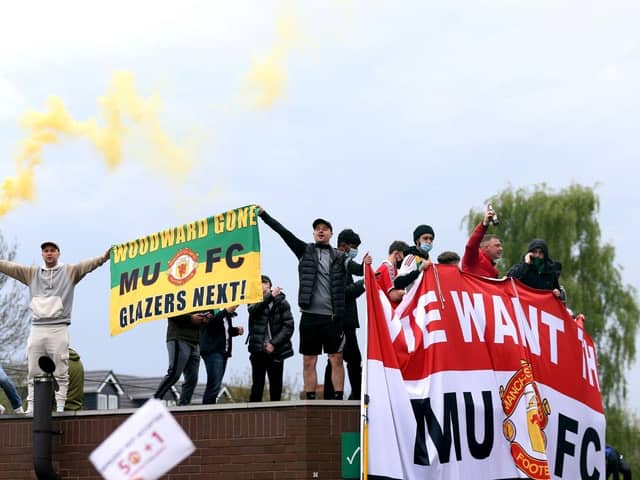 Fans holding up banners as they protest against the Glazer family, owners of Manchester United. Issue date: Monday May 3, 2021.