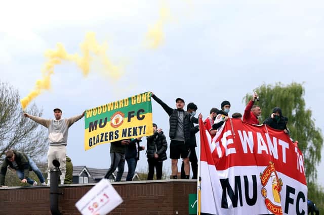 Fans holding up banners as they protest against the Glazer family, owners of Manchester United. Issue date: Monday May 3, 2021.