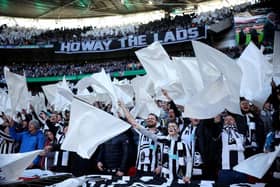 Newcastle United fans wave flags as they show their support prior to the Carabao Cup Final match between Manchester United and Newcastle United at Wembley Stadium. (Photo by Eddie Keogh/Getty Images).