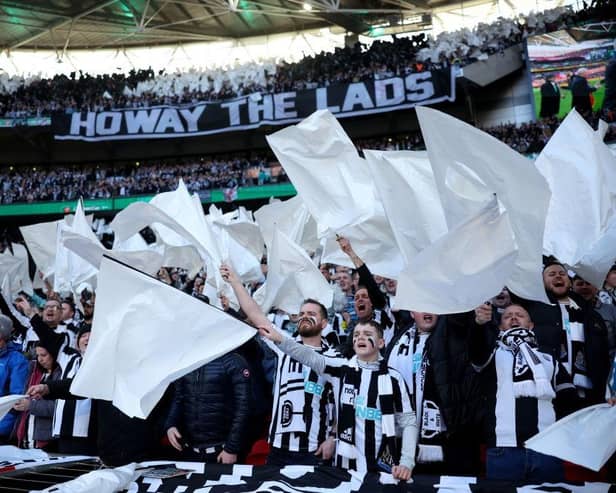 Newcastle United fans wave flags as they show their support prior to the Carabao Cup Final match between Manchester United and Newcastle United at Wembley Stadium. (Photo by Eddie Keogh/Getty Images).