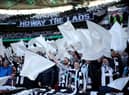 Newcastle United fans wave flags as they show their support prior to the Carabao Cup Final match between Manchester United and Newcastle United at Wembley Stadium. (Photo by Eddie Keogh/Getty Images).
