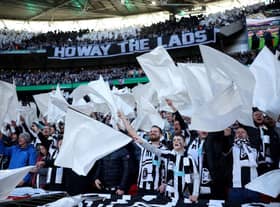 Newcastle United fans wave flags as they show their support prior to the Carabao Cup Final match between Manchester United and Newcastle United at Wembley Stadium. (Photo by Eddie Keogh/Getty Images).