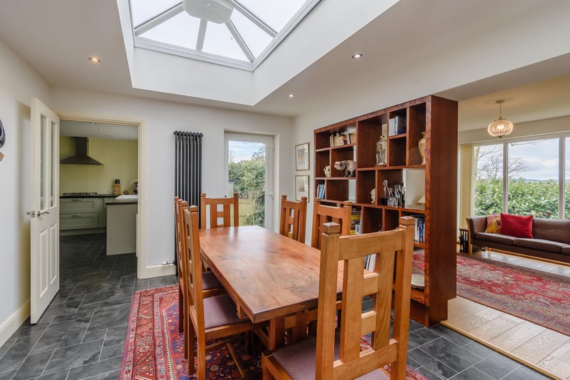 The dining room with a large sky lantern and bi-fold doors to the garden.
